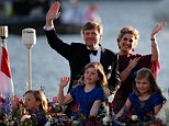 King of a river: The King and Queen smiling in a dusk object with their 3 daughters, from left, Princesses Ariane and Alexia and Crown Princess of Orange Catherine-Amalia