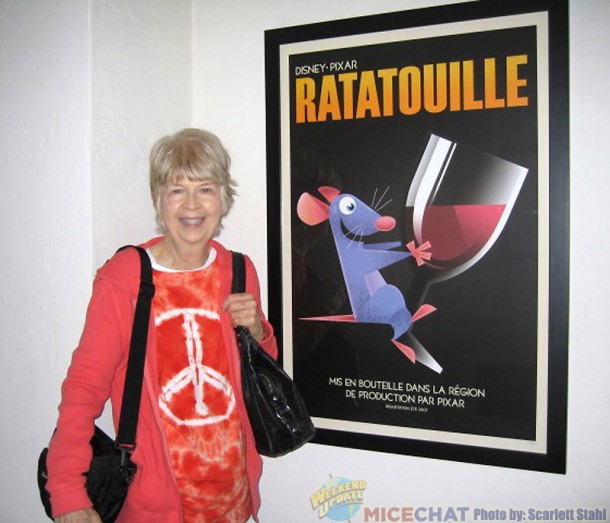 Maggie in front of a print of Ratatouille.